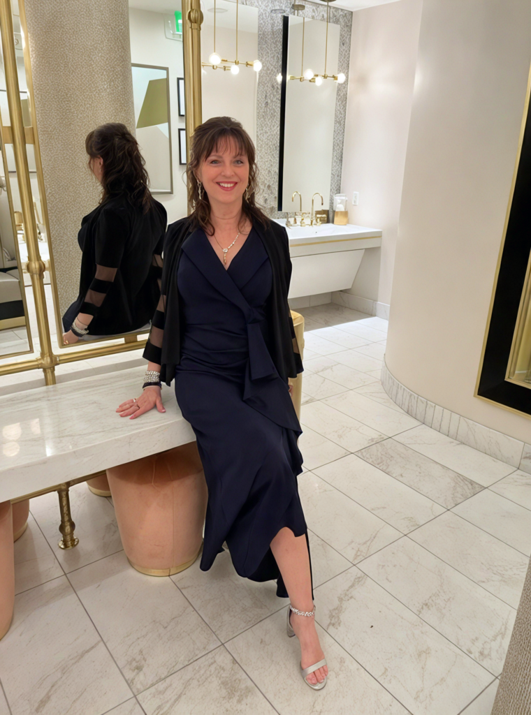 Lori Kelly poses at an elegant real estate event for home buyers and sellers